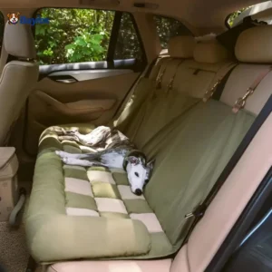 Dog resting on padded back seat cover liner secured with straps for clean and comfortable car travel