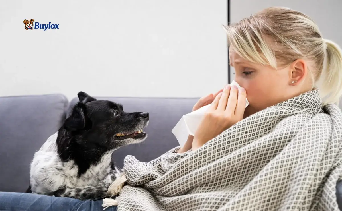 Person resting with flu symptoms while a dog lies nearby calmly at home.